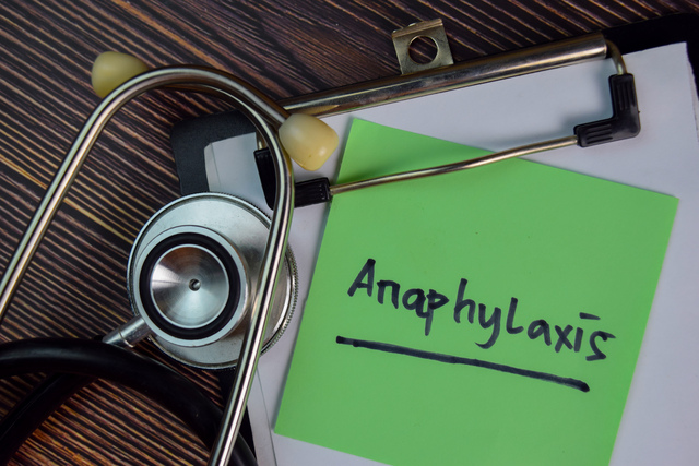 Anaphylaxis write on sticky notes isolated on Wooden Table.
